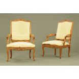 A pair of French walnut open armchairs,