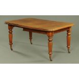 A Victorian mahogany extending dining table, rectangular, with rounded corners,