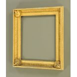 A 19th century gilt moulded picture frame, with prominent scallop mouldings to corners,