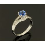 An 18 ct gold sapphire and diamond ring, sapphire +/- 1.10 carats. Size M.
