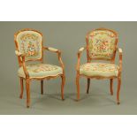 A pair of early 20th century French walnut open armchairs,