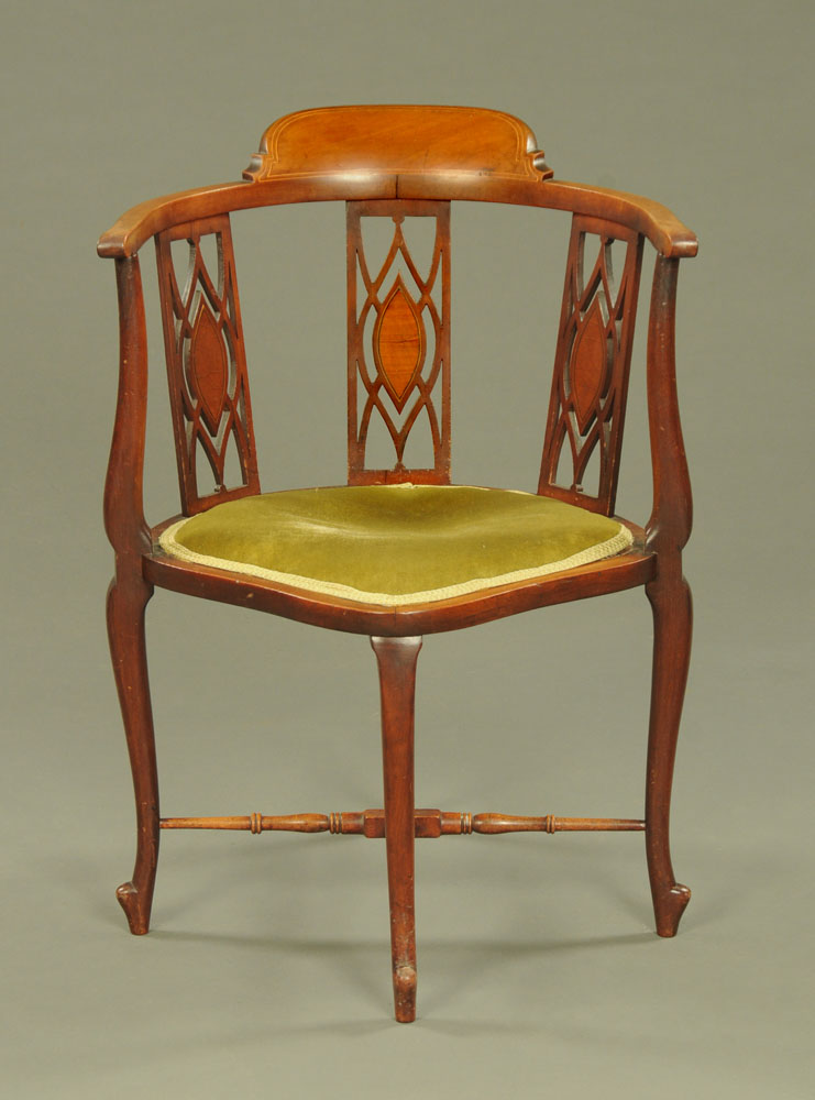 An Edwardian inlaid mahogany corner armchair, with three splat back and raised on cabriole legs.