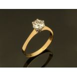 An 18 ct two tone gold solitaire ring, set with a diamond weighing +/- 1.03 ct.