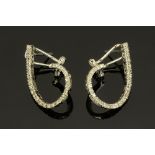A pair of 18 ct gold diamond earrings, of shaped teardrop outline.