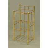 A brass shoe rack with tubular and square sections. Width 39.5 cm, height 84 cm, depth 30 cm.