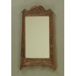 An oak framed rectangular mirror in the Arts & Crafts style. Height 63 cm, width 37 cm.