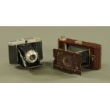 A Kodak No. 2 Hawkette Bakelite camera, and a Dacora German camera.