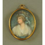 An oval miniature, lady with blue ribbon. 7 cm x 6 cm in brass frame (see illustration).