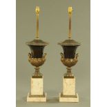 A pair of metal and marble table lamps, each in the form of a Campana shaped urn raised on a plinth.