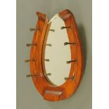 An Edwardian horseshoe shaped hall mirror, with large horseshoe nails. Height 50 cm, width 35.5 cm.