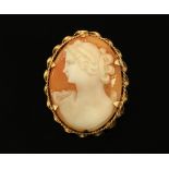 A 9 ct gold mounted oval cameo brooch, with safety chain. 43 mm x 35 mm.
