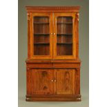 A Victorian rosewood bookcase on cupboard,