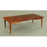 A Victorian mahogany wind out dining table with two leaves,