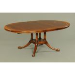 A Stewart Linford oak dining table, with centre pedestal and extra leaf.