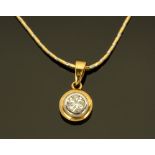 An 18 ct two tone gold pendant on chain, rubover set with a diamond weighing +/- 0.32 ct.
