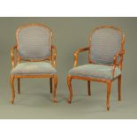 A pair of elbow chairs,