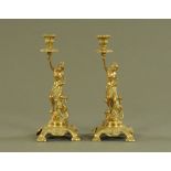 Two brass figural candlesticks, each raised on a rococo style base. Height 33 cm.