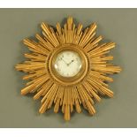 A giltwood framed Sunburst eight day wall clock, with French movement. Width 35 cm.