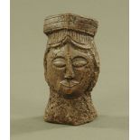 A primitive sandstone carving of a head. Height 15 cm.