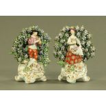 A pair of Derby figures, shepherd and shepherdess with floral encrusted bocage.
