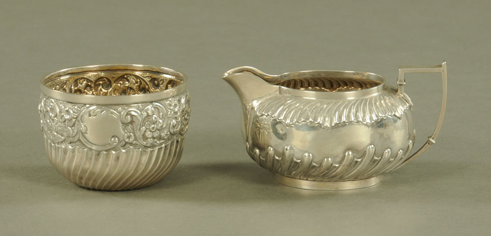 A silver cream jug, Sheffield 1892, together with a sugar basin, London 1897,