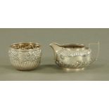 A silver cream jug, Sheffield 1892, together with a sugar basin, London 1897,