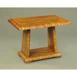An Art Deco veneered side table, with angled supports and low shelf.