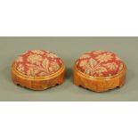 A pair of Victorian walnut circular footstools, with upholstered tops. Diameter 29 cm.