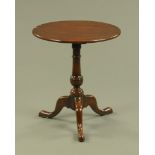 A George III style yew wood tripod table,