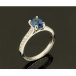 An 18 ct gold sapphire and diamond ring, sapphire +/- 1.25 carats. Size M.
