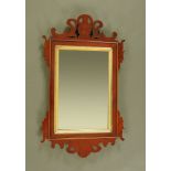 A George III mahogany fretwork wall mirror, with gilt slip. Height 52 cm, width 31 cm.