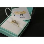 A 14ct gold and white stone ring with cross-over style shank,