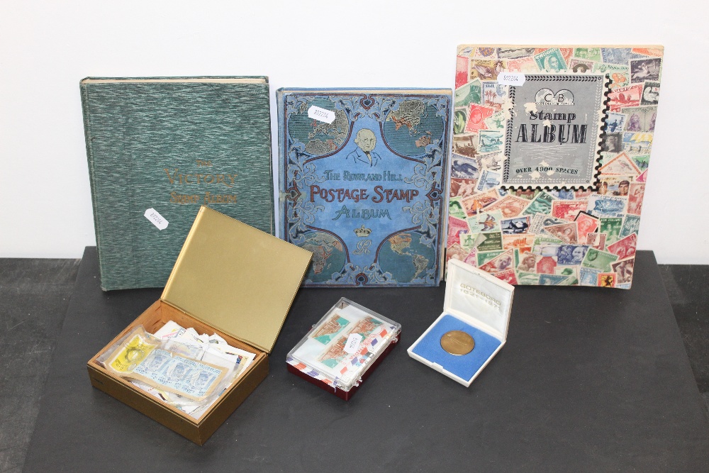 Three small stamp albums and a quantity of loose stamps,