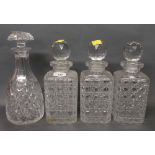 A set of three hobnail cut glass decanters, each with facet cut stoppers,