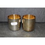 A pair of Elizabeth II 9ct gold toasting cups of simple planished design by RNRG each 6 cm diameter