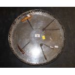 A 19th century silver plated circular tray with pierced rim and engraving to the centre,