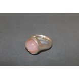 A George Jensen silver and rose quartz set ring with cabochon stone, design No:- 473, ring size J/K,