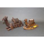 A pair of Egyptian carved wooden camel figures
