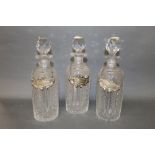 A group of three cut glass decanters,