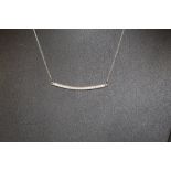 A silver and CZ bar necklace,