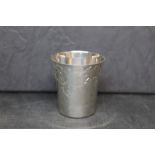 An Elizabeth II silver beaker with flared rim and engraved with leaf and floral ornaments,
