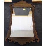 A George II mahogany rectangular wall mirror with shaped cresting and apron,