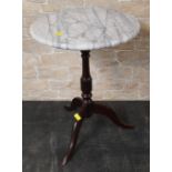 A mahogany and grey veined marble circular tripod table,