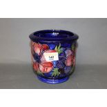 A Moorcroft pottery Anemone pattern jardiniere on a blue ground,