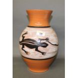 An African pottery vase, decorated in black and white with repeating lizard design,