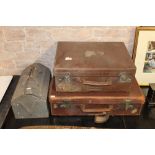 Two brown leather suitcases and a metal toolbox containing a small selection of hand tools.