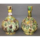 A pair of leaf moulded pottery bulbous vases of Majolica style, 25 cm (one chipped to foot rim,