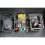 Two plastic boxes filled with rod eyes, spinner blades, Veniard special dyes for fly tiers,