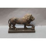 A heavy cast iron Lion door stop, with paw raised upon a ball. Height 16 cm.