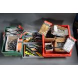 Four plastic boxes filled with sea fishing weights, Octopus bait, large treble hooks, lures etc.